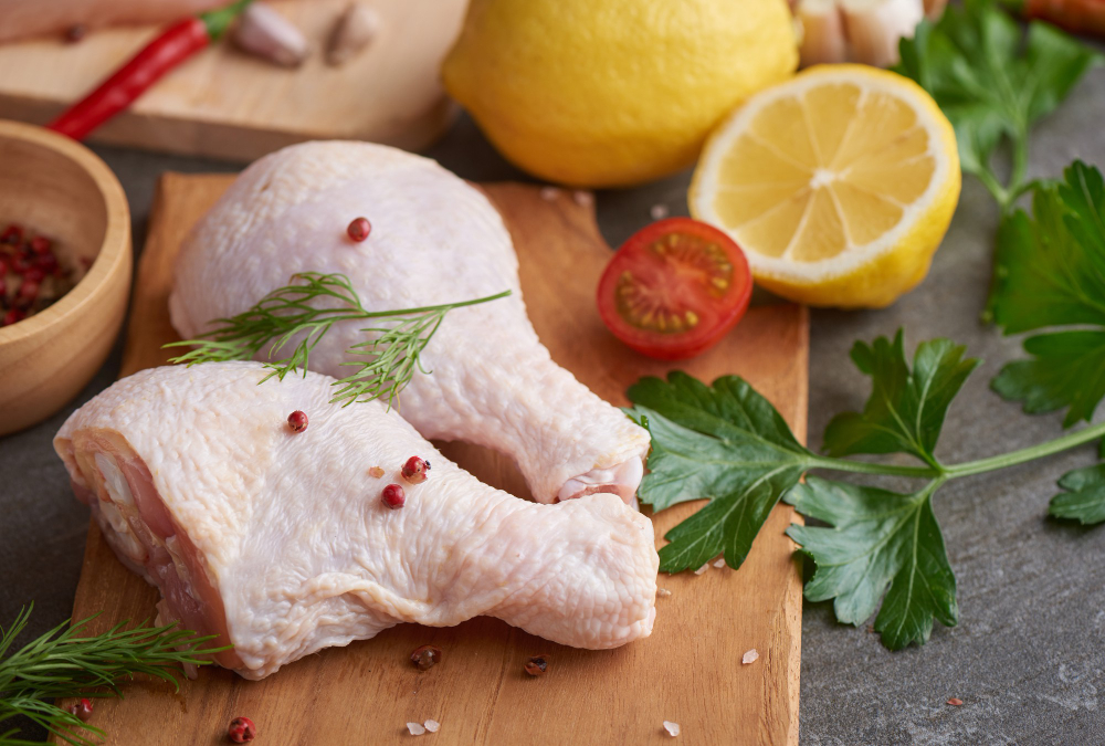 fresh-chicken-meat-portions-for-cooking-and-barbecuing-with-fresh-seasoning-raw-uncooked-chicken-leg-on-cutting-board