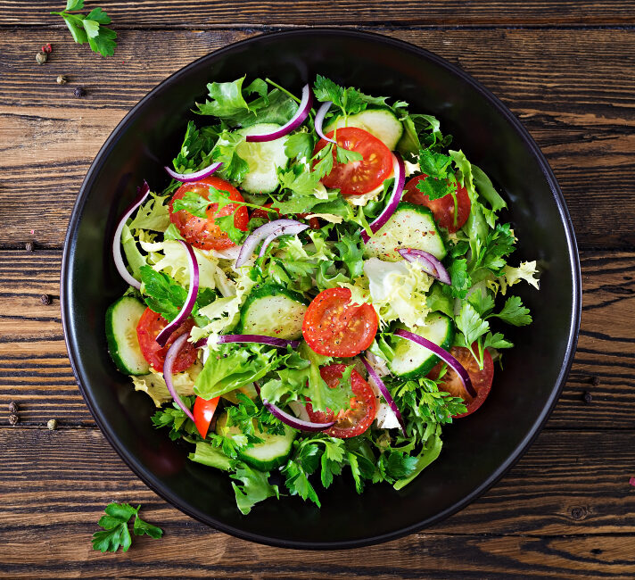 salad-from-tomatoes-cucumber-red-onions-and-lettuce-leaves-healthy-summer-vitamin-menu-vegan-vegetable-food-vegetarian-dinner-table-top-view-flat-lay